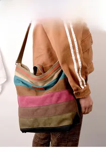 Detail of multi-color striped canvas tote bag showing textured fabric and spacious side profile