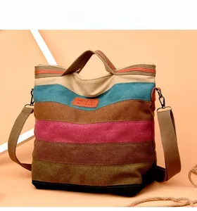 Close-up of color-block canvas tote showing textured fabric layers and leather logo