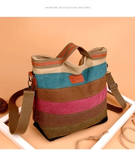 Close-up of a colorful striped canvas bag with leather straps and logo on a warm setup