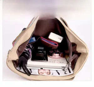 Detail view of khaki canvas tote bag interior with multiple pockets and large capacity