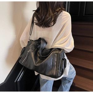 Black soft PU leather tote bag featuring functional silver zippers and side flap pocket