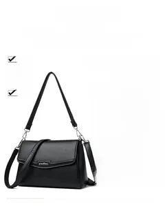 Detail of black crossbody bag with litchi texture and detachable dual shoulder straps