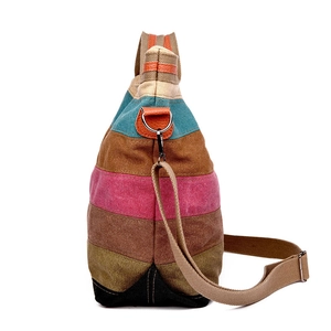 Colorful striped canvas tote bag with textured horizontal patterns and crossbody strap
