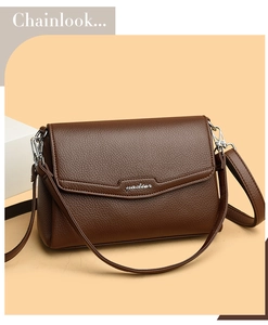Detail view of dark brown pebbled leather surface with silver Yadier logo and flap