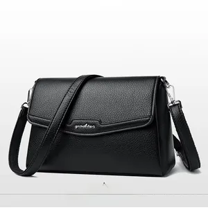 Close-up of black lychee grain leather crossbody bag with silver gadsen metal logo
