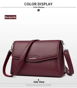 Close-up of burgundy lychee grain leather crossbody bag with silver buckle and brand logo