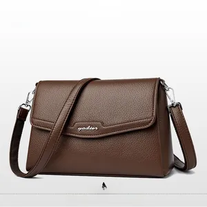 Detailed macro view of light brown pebbled leather texture and silver yadier brand logo