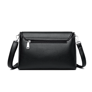 Rear view of black lychee grain leather crossbody bag with silver back zipper pocket