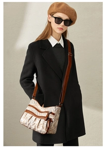 Close-up of vintage wave pattern canvas crossbody bag with multi-zipper compartments