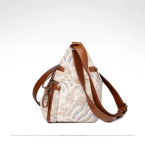 Detail view of triangular tote with Chinese wave pattern and brown leather straps