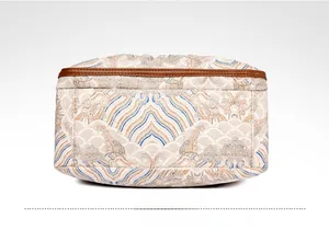 Detailed bottom view of vintage crossbody bag with Chinese wave pattern and leather edges
