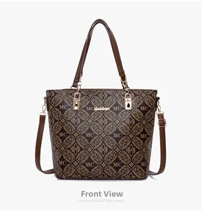 Vue de face du sac cabas vintage avec monogramme, anses en cuir marron et finitions dorées