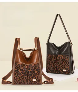 Detail of leopard print patchwork backpack with convertible straps and golden hardware