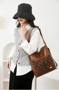 Detail of versatile brown backpack featuring leopard print pocket and adjustable straps
