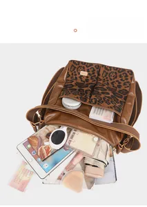 Interior view of leopard print crossbody bag showing large capacity for tablet and umbrella