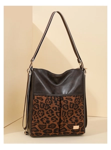 Detail of leopard print tote bag with brown faux leather trim and wide shoulder strap
