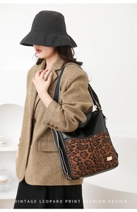 Fashionable leopard print拼接shoulder bag styled with a vintage brown wool blazer on a model
