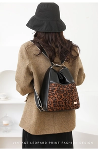 Detailed back view of a vintage leopard print backpack on a model in a casual setting