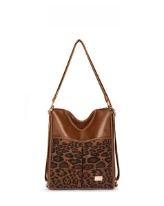 Detail of vintage tote bag featuring brown PU leather and bold leopard print panel