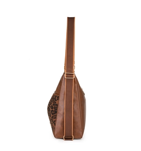 Close-up of the leopard print side pocket and wide fabric strap on this brown crossbody bag