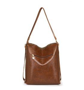 Close-up of brown PU leather texture and golden hardware on the multi-use backpack
