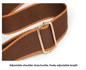 Detail of adjustable woven shoulder strap with gold metal buckle for versatile handbags