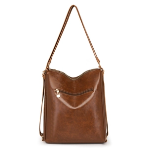 Versatile brown leather backpack and shoulder bag with vintage texture on white background