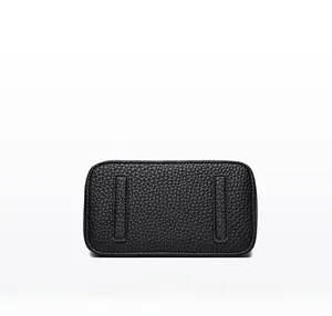 Macro shot of black pebbled leather bag bottom with reinforced protective leather strips