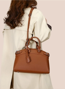 Detailed back view of a brown pebbled leather tote bag with elegant shoulder strap
