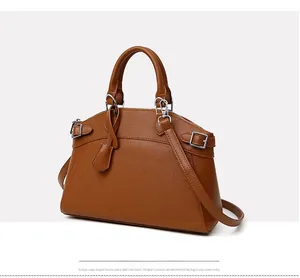 Detail of caramel lychee grain tote bag showing silver metal hardware and top handles