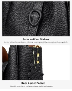 Close-up of black lychee leather bag with uniform stitching and bear charm