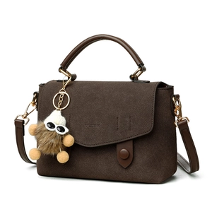 Stylish dark brown messenger bag with plush charm and detachable shoulder strap for women