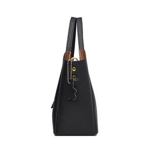 Black pebbled leather bucket bag with contrasting caramel lining and gold hardware