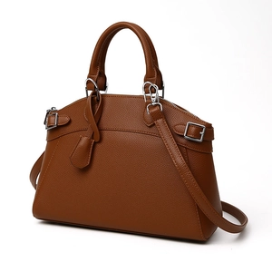 Caramel brown pebbled leather tote bag with silver hardware and adjustable shoulder strap