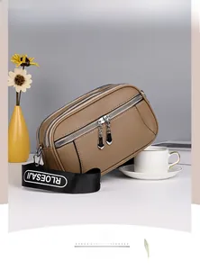 Detailed view of the triple zipper brown crossbody bag with a textured pebble leather finish