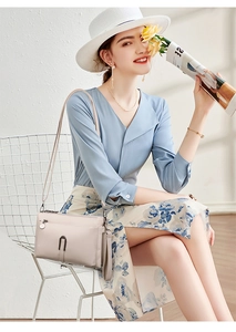 Chic beige textured leather crossbody bag with metal U-buckle shown in a lifestyle setting