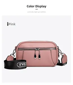Pink lychee texture leather crossbody camera bag with silver dual zippers and wide strap