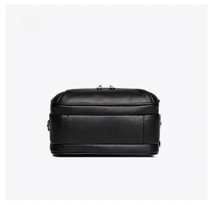Detailed bottom view of black faux leather crossbody bag with pebble texture and stitching