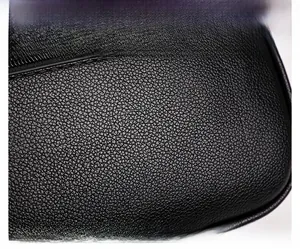Macro shot of high-quality black lychee pattern leather texture and zipper detail