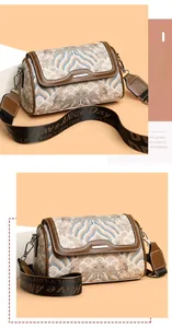 Detail of vintage embroidery pattern on handbag with wide shoulder strap and leather trim