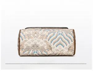 Detailed base view of vintage embroidery handbag showing intricate brocade texture and leather trim