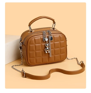 Brown quilted PU leather handbag with bear charm and metallic chain strap detail