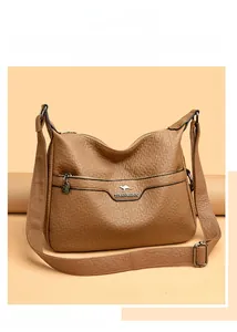 Close-up of caramel leather shoulder bag with lychee texture and kangaroo logo