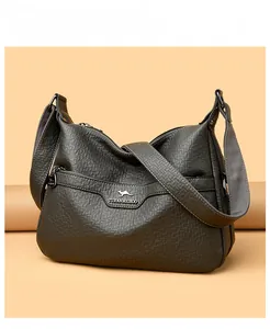 Macro view of soft lychee texture leather and kangaroo metal logo on crossbody bag