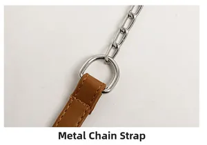 Macro detail of brown leather strap connected to silver metal chain with a D-ring