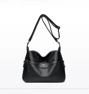 Detailed front view of black litchi pattern leather crossbody bag with metal kangaroo logo