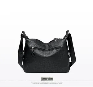 Detail view of the black pebbled leather handbag back with a horizontal zipper pocket