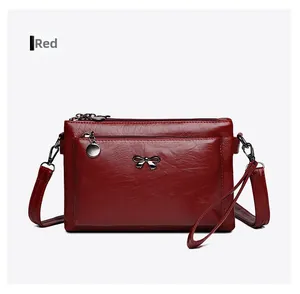 Detailaufnahme der roten PU-Lederhandtasche mit Metallschleife und strukturierter Optik