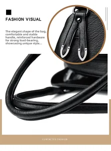 Detail of soft black lychee grain leather handbag with silver metal hardware and handle