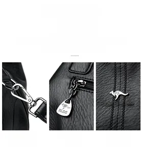 Detail of hardware components including a snap hook, zipper pull, and logo on black leather